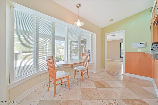 dining room featuring vaulted ceiling