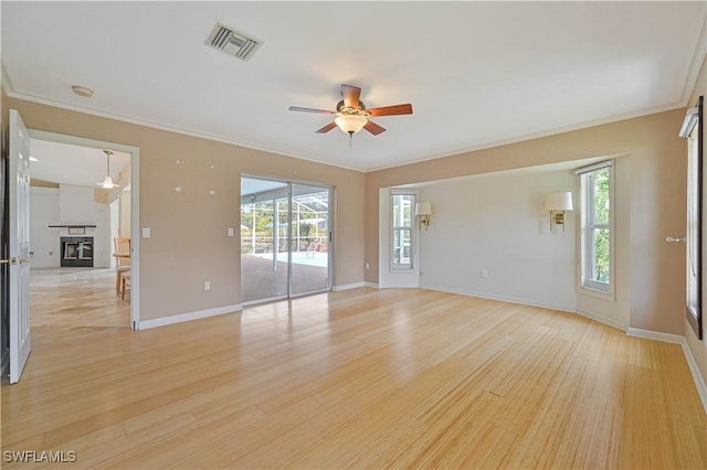 spare room with crown molding, light hardwood / wood-style flooring, and ceiling fan