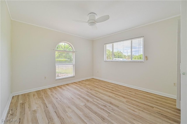 spare room with crown molding, ceiling fan, and light hardwood / wood-style flooring