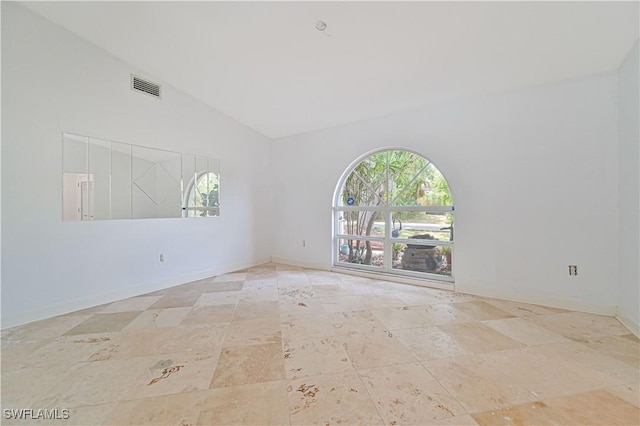 spare room with high vaulted ceiling