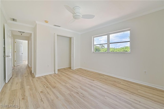 unfurnished bedroom featuring ceiling fan, ornamental molding, light hardwood / wood-style floors, and a closet