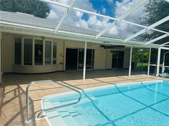 view of swimming pool with a patio and glass enclosure