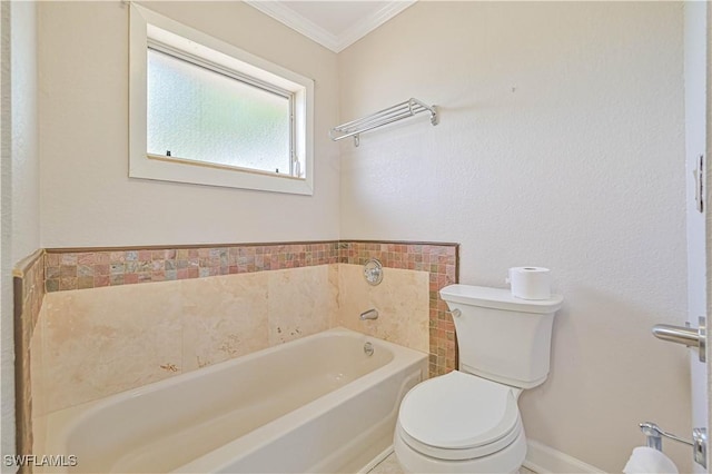 bathroom featuring crown molding, a tub, and toilet