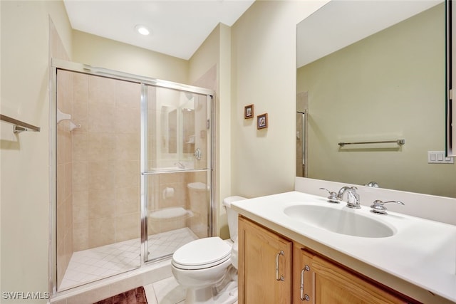 bathroom featuring vanity, toilet, a shower with shower door, and tile patterned flooring