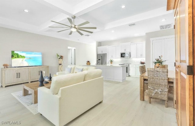 living room with ceiling fan, coffered ceiling, beam ceiling, and light hardwood / wood-style flooring