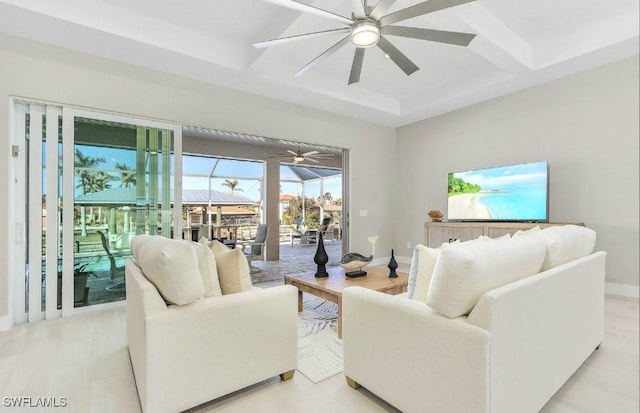 living room with beamed ceiling, coffered ceiling, and ceiling fan