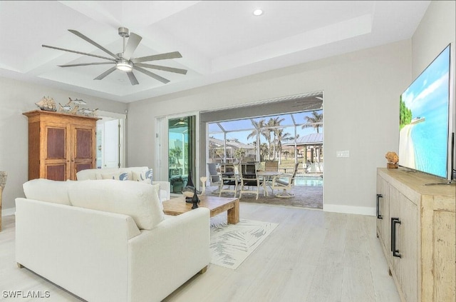 living room featuring beamed ceiling, coffered ceiling, ceiling fan, and light hardwood / wood-style flooring