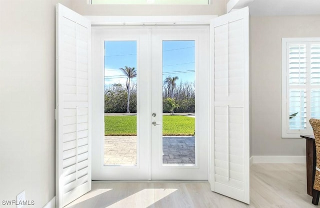 entryway with light wood-type flooring and french doors