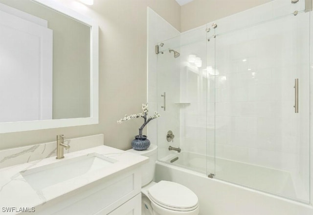 full bathroom featuring toilet, vanity, and bath / shower combo with glass door