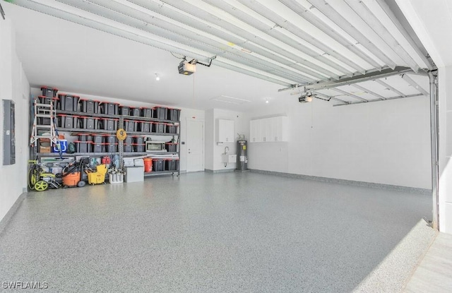 garage featuring a garage door opener, electric panel, and electric water heater