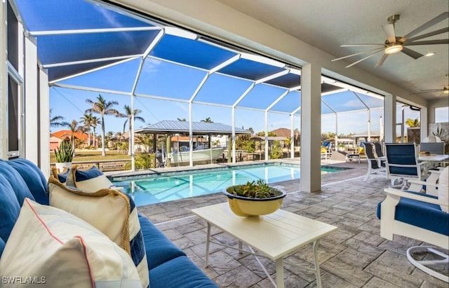 view of pool with a patio, a lanai, outdoor lounge area, and ceiling fan