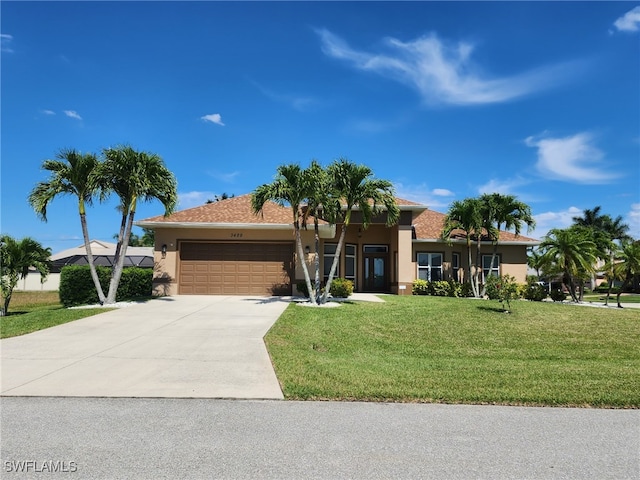 single story home featuring a garage and a front lawn