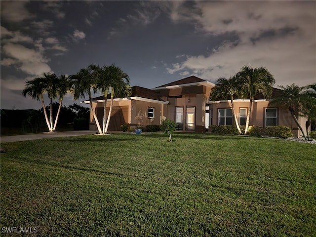 view of front of house featuring a front yard and a garage