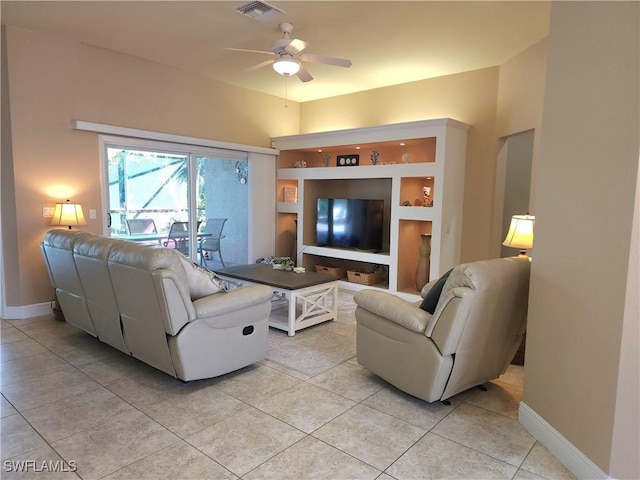 tiled living room featuring ceiling fan and built in shelves