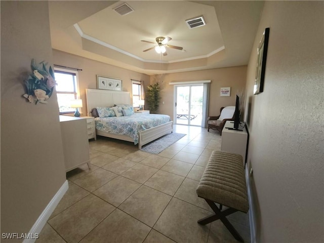 tiled bedroom featuring crown molding, a raised ceiling, multiple windows, and access to outside