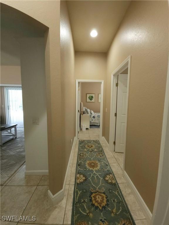 hallway featuring light tile patterned flooring