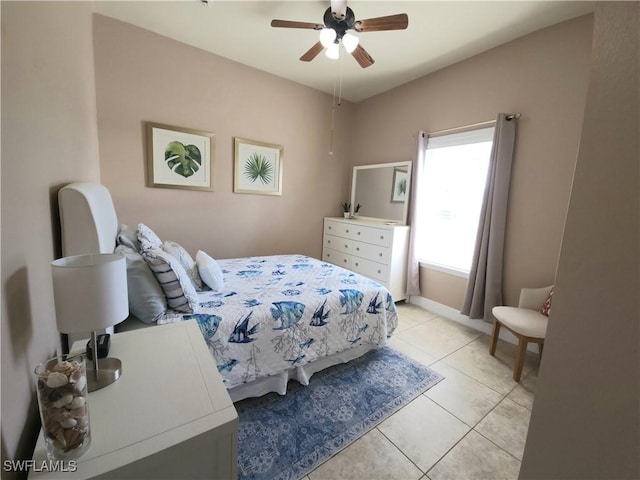 tiled bedroom featuring ceiling fan