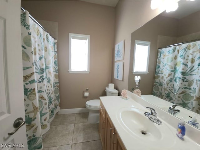 bathroom with vanity, toilet, curtained shower, and tile patterned flooring