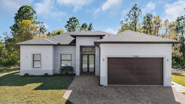 view of front of property featuring a garage and a front yard