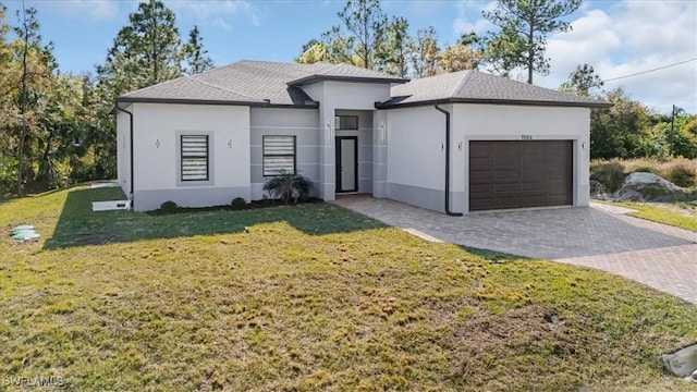 view of front of home featuring a garage and a front yard