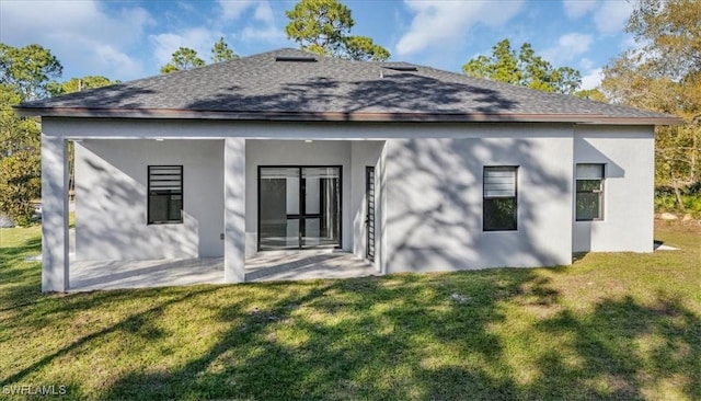 rear view of house featuring a yard and a patio area