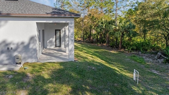 view of yard with ceiling fan