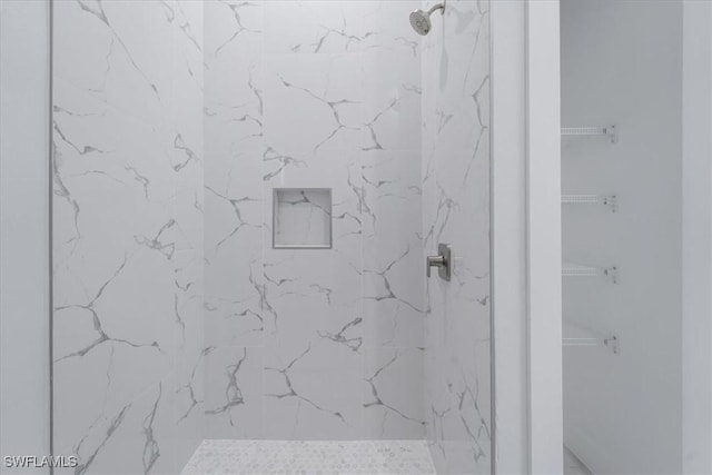 bathroom with tiled shower