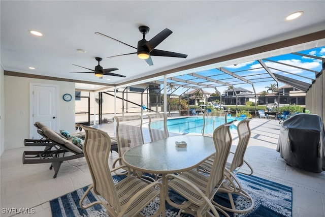 view of patio featuring ceiling fan, a grill, and a lanai