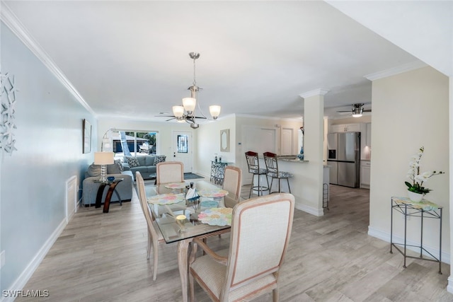 dining space with ornamental molding, ceiling fan with notable chandelier, and light hardwood / wood-style floors