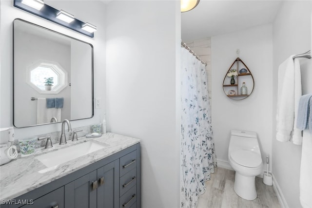 bathroom featuring a shower with curtain, vanity, hardwood / wood-style floors, and toilet