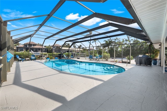 view of swimming pool featuring grilling area, a lanai, and a patio area