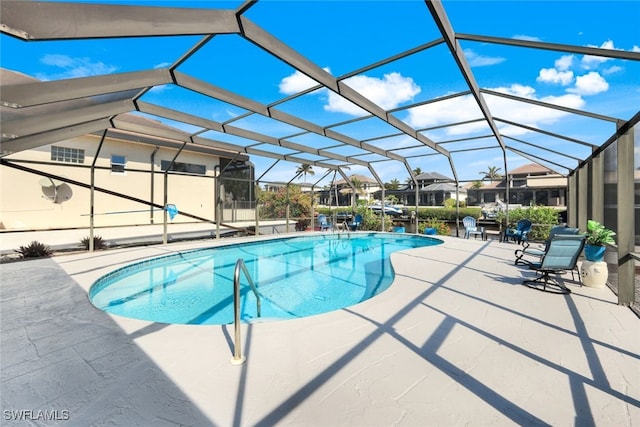 view of swimming pool with a lanai and a patio area