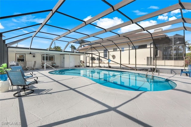 view of pool featuring a patio, ceiling fan, and glass enclosure