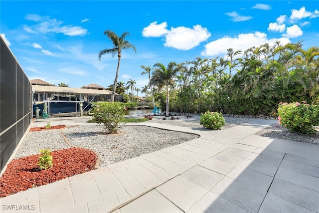 exterior space with a water view and a patio area