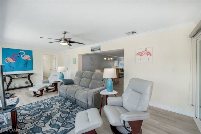 living room featuring crown molding, ceiling fan with notable chandelier, and light hardwood / wood-style floors