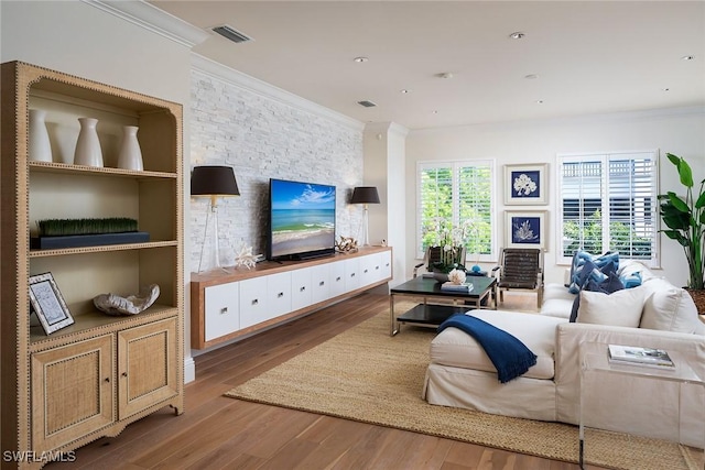 living room featuring ornamental molding and light hardwood / wood-style floors