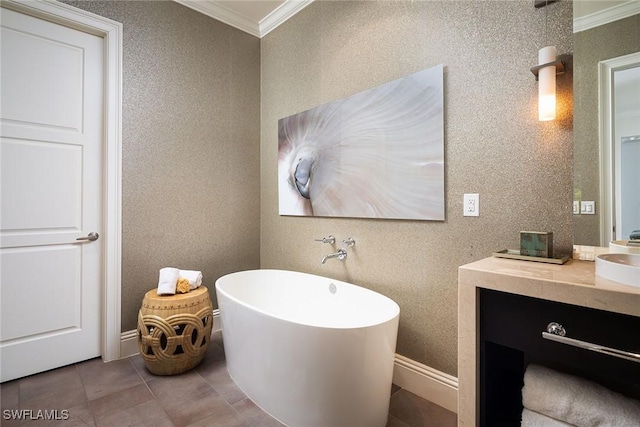 bathroom featuring vanity, tile patterned flooring, a bathtub, and ornamental molding