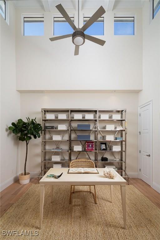 interior space with hardwood / wood-style floors and ceiling fan