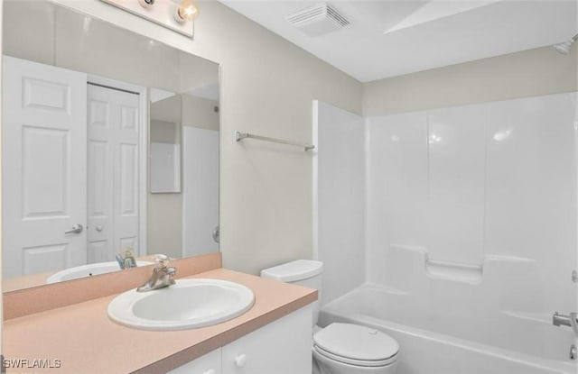 full bathroom with vanity, tub / shower combination, and toilet