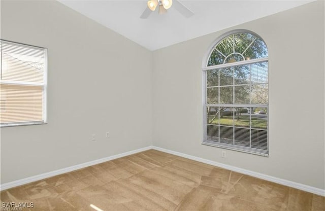 carpeted empty room with lofted ceiling and ceiling fan