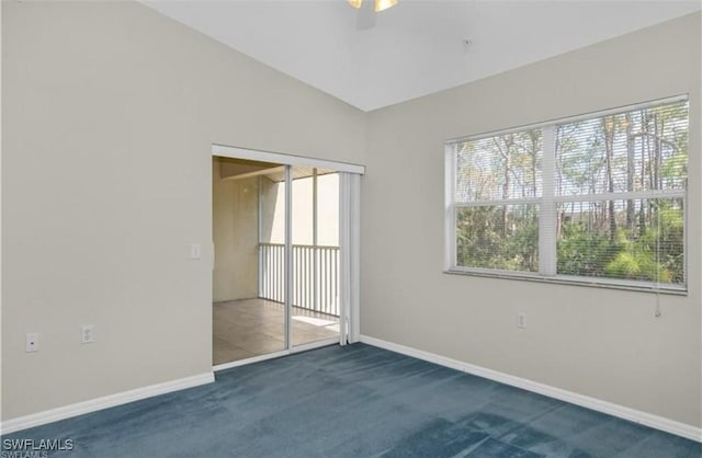 carpeted spare room featuring lofted ceiling and ceiling fan