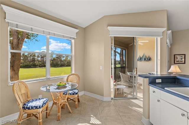 interior space with a ceiling fan and baseboards