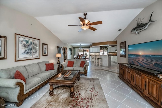 living room featuring lofted ceiling, light tile patterned floors, and ceiling fan