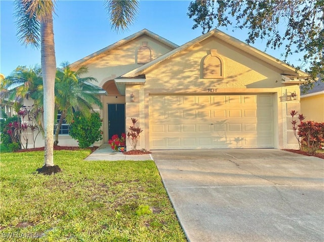 view of front of house with a garage and a front yard