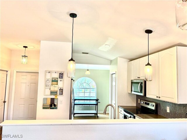 kitchen with white cabinetry, pendant lighting, kitchen peninsula, and appliances with stainless steel finishes