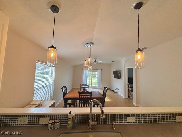 dining room with lofted ceiling and sink