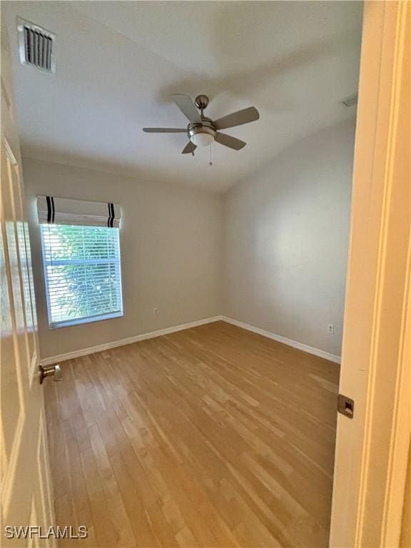 spare room with wood-type flooring and ceiling fan