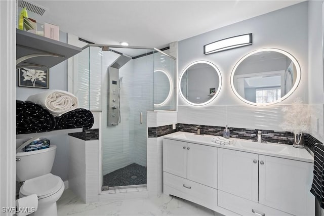 bathroom featuring vanity, toilet, a shower with door, and backsplash