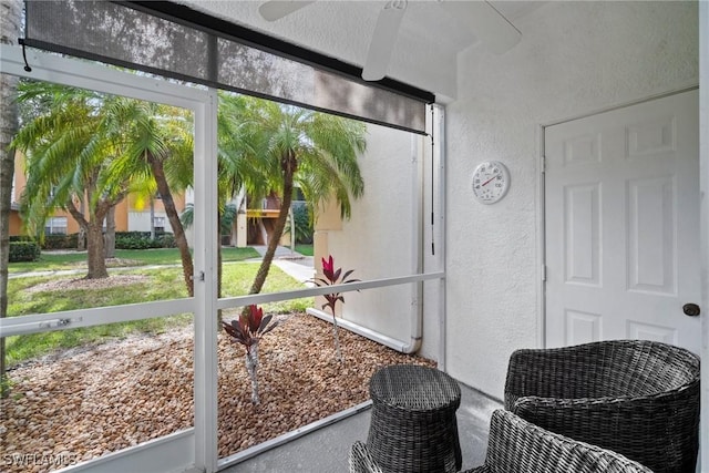 sunroom / solarium with a healthy amount of sunlight and ceiling fan