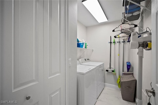 laundry area featuring washing machine and clothes dryer and a skylight